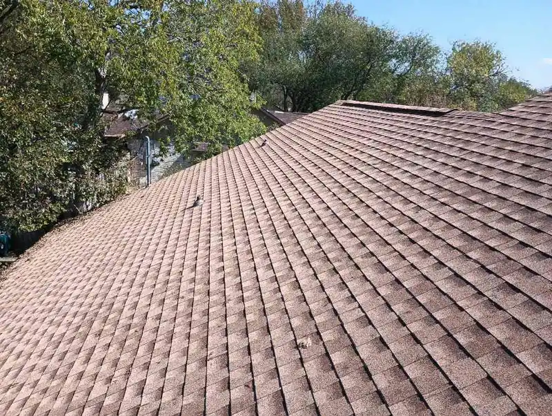 Clean run of brown architectural shingles across a finished roof slope