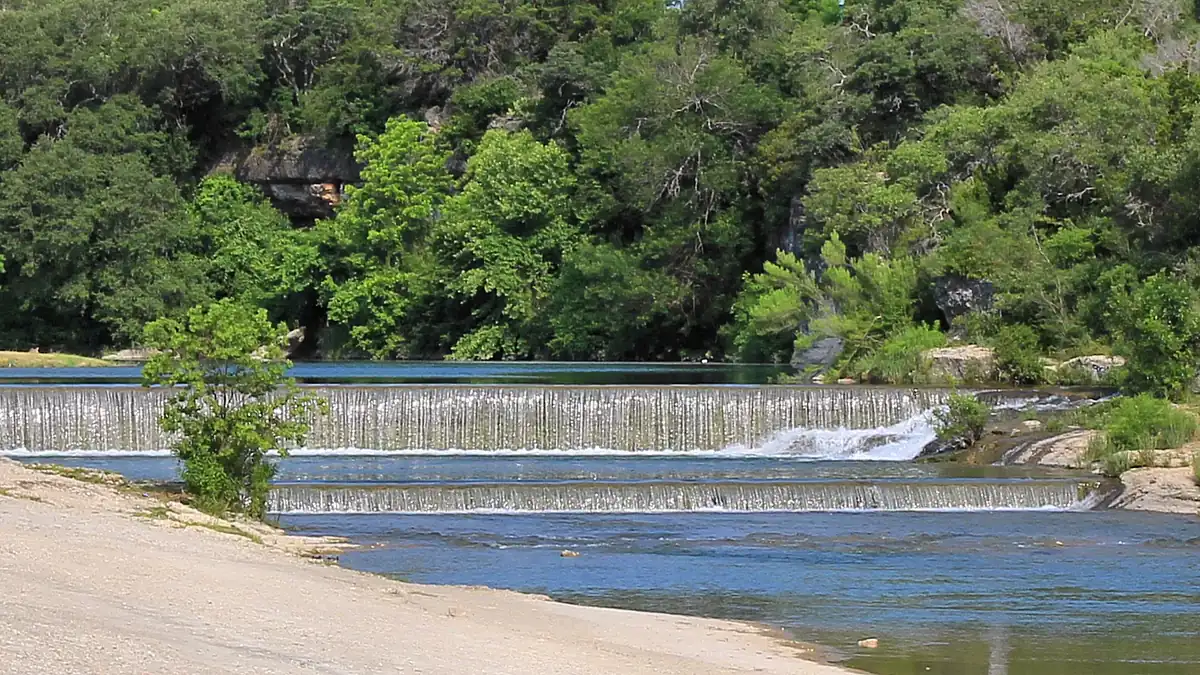Water spilling over the low dam on the San Gabriel River at Blue Hole Park in Georgetown