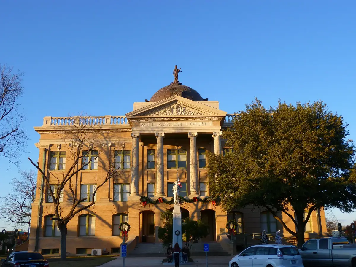 The Williamson County Courthouse dome and columned front on the Georgetown square in late afternoon sun