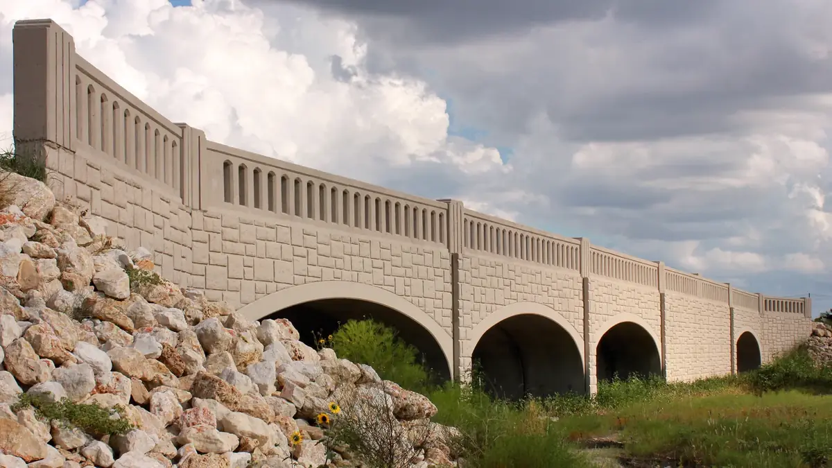 The arched bridge over the South Fork of Brushy Creek in Leander under a cloudy sky